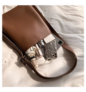 Brown leather tote bag interior view showing large storage capacity with daily essentials