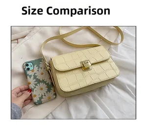 Size comparison between a light yellow crocodile pattern shoulder bag and a mobile phone