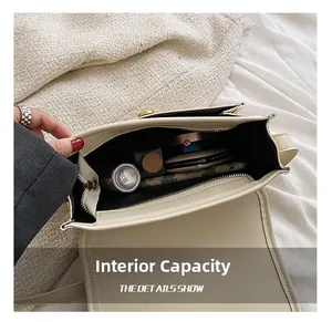 Interior view showing the capacity of the beige crossbody bag with makeup items