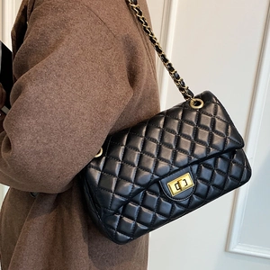 Classic black quilted leather crossbody bag with gold chain strap and metal lock