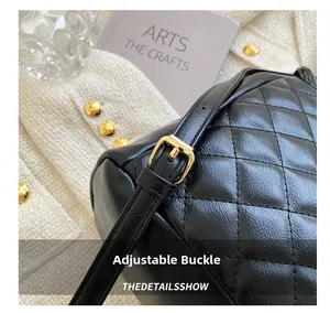 Detail of adjustable golden metal buckle on black quilted leather backpack strap