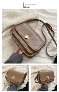 Detail of khaki quilted crossbody bag featuring a golden circular twist lock closure