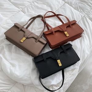 French vintage underarm bags in taupe, rust red, and black with golden turn-lock buckles