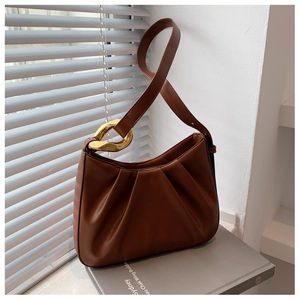 Detail of brown pleated hobo bag featuring premium matte leather and gold chain link