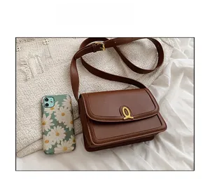 Brown vintage PU leather crossbody bag with oval gold clasp and adjustable strap
