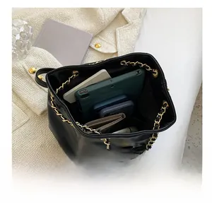 Interior view of black quilted leather backpack showing spacious capacity for daily essentials