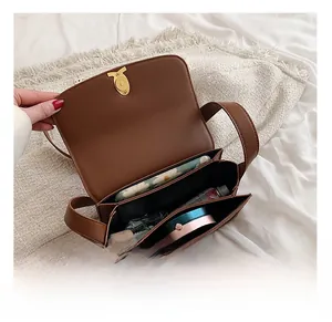 Internal view of brown leather bag showing dual compartments and storage capacity