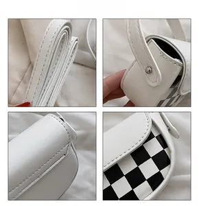 Détails des coutures et boucles métalliques du petit sac de selle en damier blanc