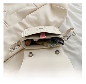 Internal view of cream quilted crossbody bag showcasing storage space for daily essentials