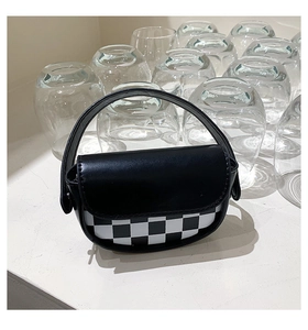 Gros plan du mini sac selle avec rabat en cuir noir et détails à motif damier