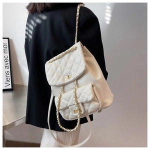 Quilted cream backpack with gold chain straps and turn-lock shown on a model