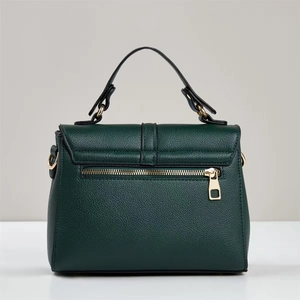 Detail of dark green lychee pattern leather square bag featuring a gold back zipper pocket