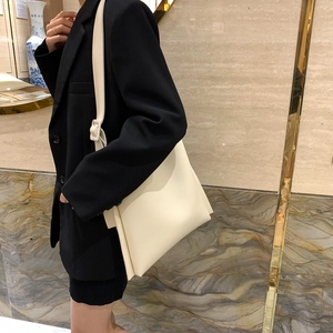 Minimalist large capacity cream shoulder bag with adjustable strap for office commuting