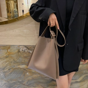 Minimalist large capacity taupe tote bag with wide shoulder strap for professional commuting