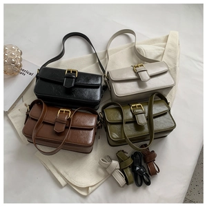 Detail of retro flap bags in four colors with gold buckle and adjustable straps