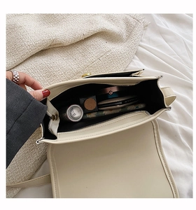 Interior view of beige PU leather shoulder bag showing main compartment and zipper pocket