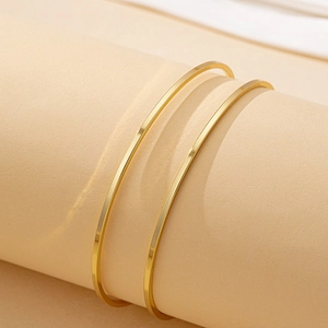 Minimalist adjustable gold coil arm cuffs set with polished rectangular finish