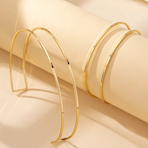 Minimalist double-layered gold geometric collar necklace with sleek metallic finish