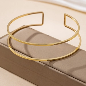 Minimalist double layer gold choker necklace with adjustable open design on leather box