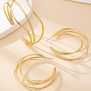 Detail of gold multilayer geometric hollow hoop earrings with stylish C-shaped design
