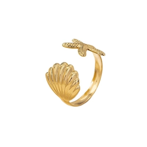 Adjustable golden open ring featuring detailed ocean scallop and starfish elements