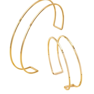 Minimalist double-line golden open bangles with geometric ends on a white background