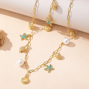 Golden paperclip chain necklace with blue starfish, shell charms and pearls