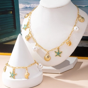 Gold-plated ocean jewelry set with teal enamel starfish, shells and pearls on clip chains