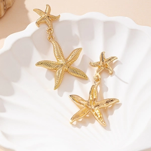 Vintage golden starfish dangle earrings for women in a nautical summer beach style