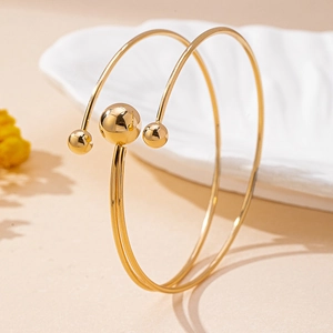 Minimalist gold open cuff bracelet set featuring polished metallic ball accents for women