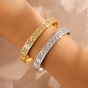 Gold and silver clover bracelets with sparkling rhinestones and serrated edges