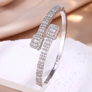 Detail of silver open bangle with pavé-set cubic zirconia and polished chrome finish