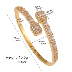Macro view of gold open bangle with baguette zirconia showing detailed dimensions and weight