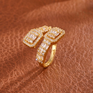 Macro detail of gold open ring with double rectangular pave zircons on brown leather