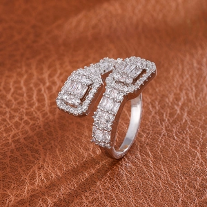 Macro detail of silver open ring with pave-set rectangular and round cubic zirconia diamonds