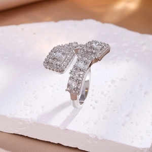 Macro detail of silver ring featuring rectangular pavé diamonds on textured stone
