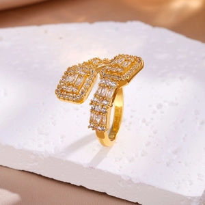 Macro shot of gold bypass ring featuring channel-set rectangular cubic zirconia stones