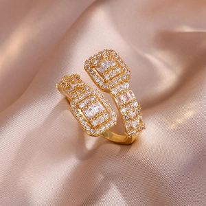 Macro view of gold open ring with rectangle geometric pattern and pavé zircons