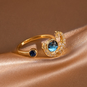Close-up of gold star and moon ring with blue sandstone and sparkling crystal details