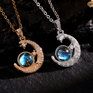 Detail of crescent moon necklaces with starry blue glass beads in gold and silver finish