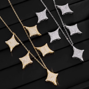 Detail of gold and silver four-pointed star necklaces with full zircon micro-paving