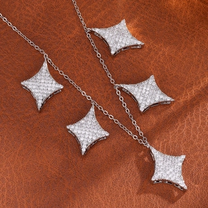 Elegant silver star necklace with sparkling diamond pendants on dark leather texture