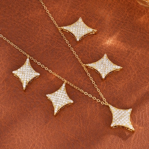 Luxury gold necklace featuring four-pointed star pendants with micro-pave zircon stones