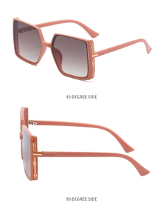 Detail view of pink TR square sunglasses with gold metal hinges and gradient brown lenses