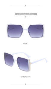 Close-up of white square sunglasses with purple gradient lenses and gold T-decorations
