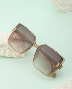 Detail of champagne square sunglasses with gradient lenses and gold metal temple accents