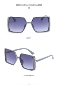 Detail of square oversized gray gradient sunglasses with striped metal temple accents