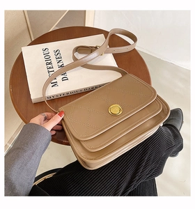 Minimalist khaki crossbody bag with quilted lattice pattern and round metal clasp detail