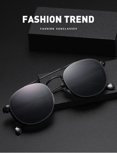 Detail view of oval frame sunglasses showing inner temple specifications and metal finish