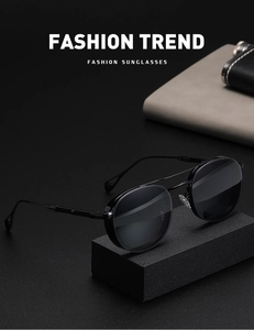 Detail of retro oval black metal sunglasses on a sleek matte base with fashion props